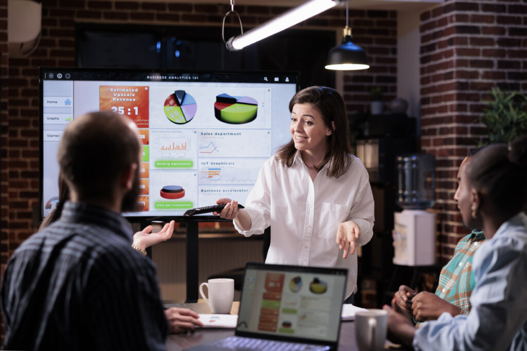 A woman is presenting among her colleagues