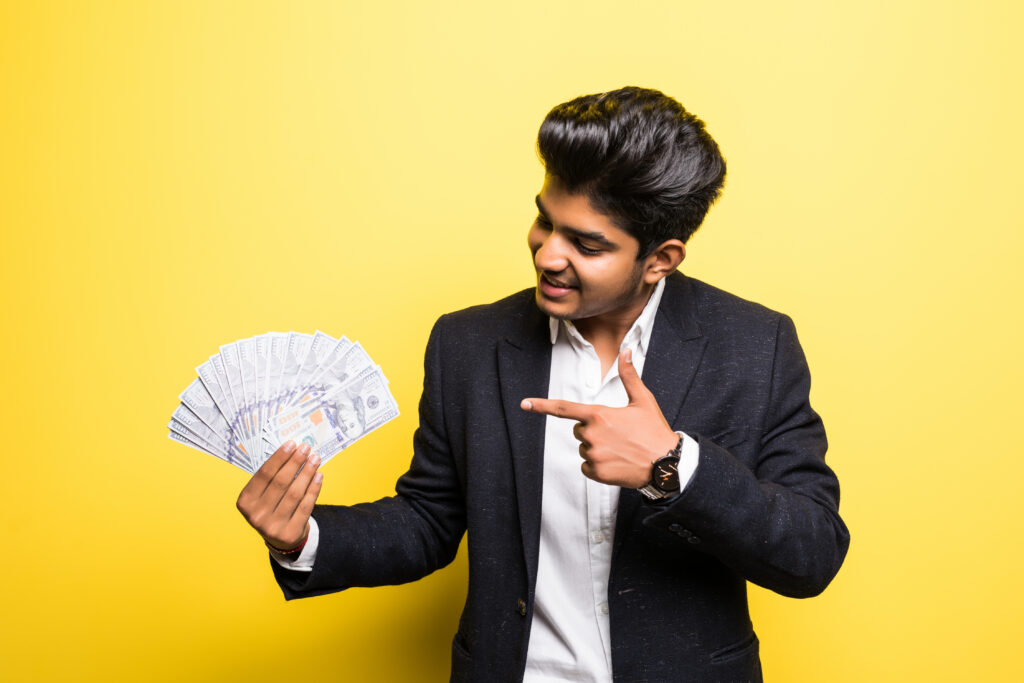 Indian entrepreneur with dollar banknotes in hand